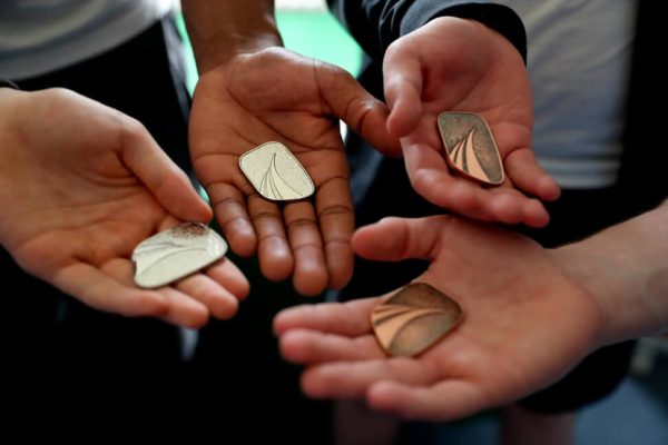 award partners image of hands holding medals