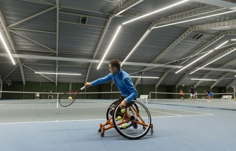 boy in wheelchair playing tennis