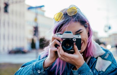 girl with pink hair taking a photo